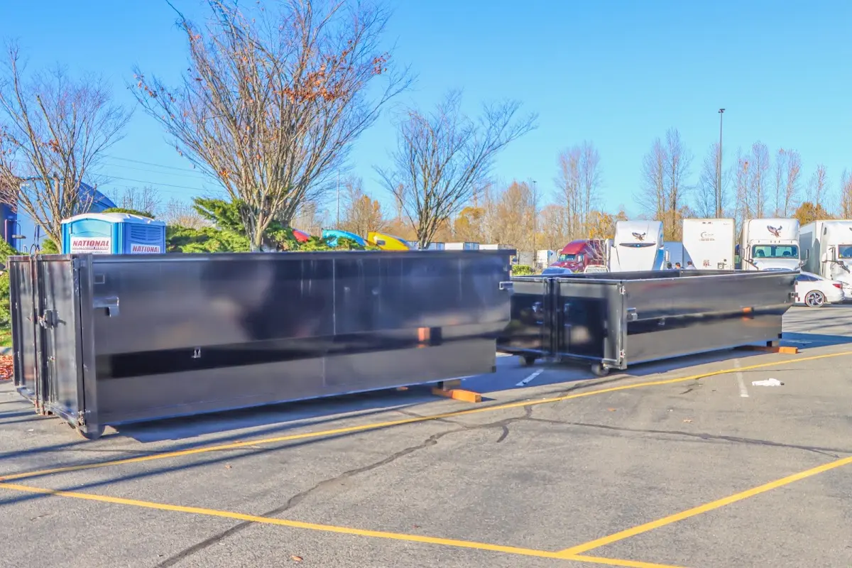 Professional dumpster rental service with roll-off container on residential driveway in Bryans Road